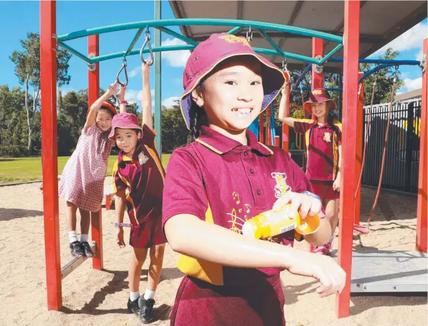  ?? Picture: JUSTIN BRIERTY ?? SPREAD THE WORD: Edge Hill Primary School students Iroha Matsui, 8, Matty McWhinney, 8, Minh-Chau Bui, 10 and Rhea Halkidis, 10, cover up from the sun.