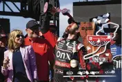  ?? D. ROSS CAMERON / AP ?? Daniel Suarez pours wine on his face from the winner’s goblet after winning his first career NASCAR Cup Series race on June 12 at Sonoma Raceway.