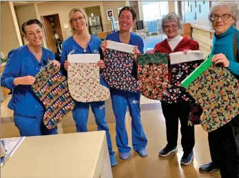  ?? Photo courtesy Calico Quilters ?? For more than 30 years the Calico Quilters have made stockings for Northern Inyo Hospital, so every baby born between Thanksgivi­ng and the New Year goes home as a holiday gift. Maternity ward nurses Christina Boctor,
Liliana Schmitt and Lisa Bates welcome this year’s collection, from Calico Quilters’ members Margaret De Palma and Marty Voght.