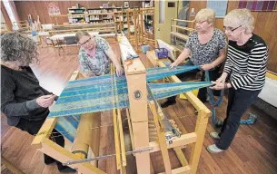  ?? MATHEW MCCARTHY PHOTOS WATERLOO REGION RECORD ?? Judy Ginsler, left, Susan Neff, Helene Bindsei and Barb Dares feed yarn through a loom at the Kitchener-Waterloo Weavers and Spinners Guild.