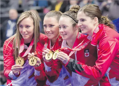  ?? JUSTIN TANG/THE CANADIAN PRESS ?? Skip Rachel Homan, third Emma Miskew, second Joanne Courtney and lead Lisa Weagle hold up their medals after winning the women’s final 6-5 over Cheslea Carey’s rink at the Roar of the Rings Olympic trials on Sunday in Ottawa.