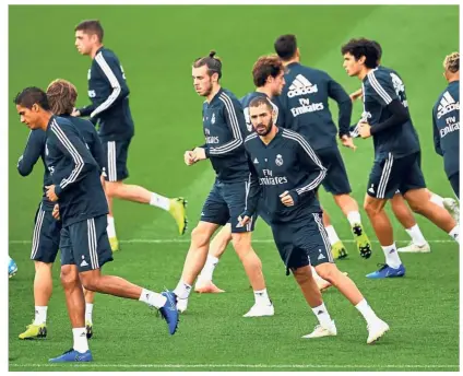  ?? — AFP ?? Hard at work: Real Madrid players warming up during a training session at the Valdebebas training ground in Madrid yesterday.