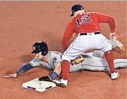  ?? BRIAN FLUHARTY/USA TODAY SPORTS ?? Astros third baseman Alex Bregman is tagged by Red Sox second baseman Brock Holt in Game 1 of the ALCS on Saturday.