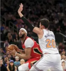  ?? SETH WENIG — THE ASSOCIATED PRESS ?? New Orleans Pelicans’ Anthony Davis, right, looks at the basket past New York Knicks’ Doug McDermott during the first half of an NBA basketball game, Sunday in New York.