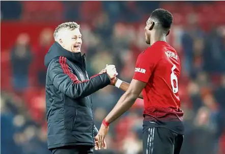  ?? — Reuters ?? Good job: Manchester United interim manager Ole Gunnar Solskjaer (left) shaking hands with Paul Pogba after the Premier League match against Huddersfil­ed on Wednesday.