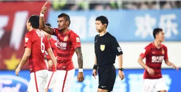  ?? — AFP photo ?? Paulinho of Guangzhou Evergrande (second left) gesturing during the team’s Chinese Super League match against Beijing Guoan in Guangzhou in China’s Guangdong province in this March 5, 2017 file photo.