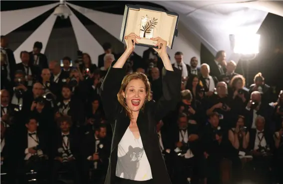  ?? ?? Justine Triet, winner of the Palme d'Or for 'Anatomy of a Fall,' poses for photograph­ers during a photo call following the awards ceremony at the 76th internatio­nal film festival, Cannes, southern France. Photo:Daniel Cole, AP