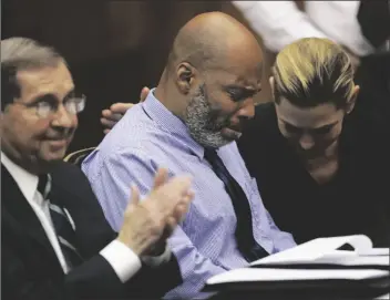  ?? CHRISTIAN GOODEN/POOL ST. LOUIS POST-DISPATCH VIA AP ?? LAMAR JOHNSON (CENTER) AND HIS ATTORNEYS react on Tuesday after St. Louis Circuit Judge David Mason vacated his murder conviction during a hearing in St. Louis, Mo.