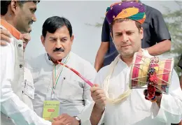  ?? — PTI ?? Congress vice-president Rahul Gandhi plays a musical instrument at a programme at Harij in Patan district on Monday.