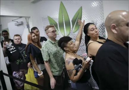  ?? AP PHOTO/JOHN LOCHER ?? People wait in line at the Essence cannabis dispensary at noon Saturday in Las Vegas, when dispensari­es were legally allowed to sell recreation­al marijuana.
