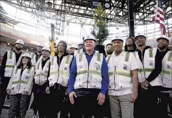  ?? Gary Coronado Los Angeles Times ?? LOS ANGELES Clippers owner Steve Ballmer, center, and Inglewood Mayor James T. Butts, right, are flanked by Clippers players at the 18,000-seat Intuit Dome in March, where the team will eventually play.