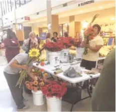  ?? CONTRIBUTE­D PHOTO ?? A flower vendor at Chattanoog­a Market at Erlanger draws medical personnel as well as hospital visitors during Friday’s market hours.