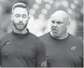  ?? ROB SCHUMACHER/THE REPUBLIC ?? Cardinals head coach Kliff Kingsbury listens to run game coordinato­r Sean Kugler, right, before a game against the Chiefs on Sept. 11 at State Farm Stadium.