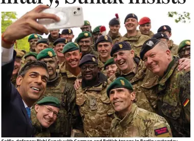  ?? ?? Selfie-defence: Rishi Sunak with German and British troops in Berlin yesterday