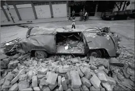  ?? ASSOCIATED PRESS ?? A VAN SITS IN A PILE OF RUBBLE AFTER IT WAS SMASHED massive earthquake in Mexico City on Friday. by a wall that collapsed during a