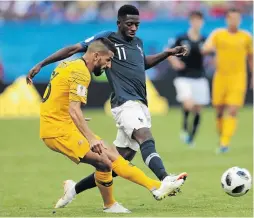  ?? /ANATOLIJ MEDVED/NURPHOTO ?? Aziz Behich of Australia, left, clears the ball away from French striker Ousmane Dembele.