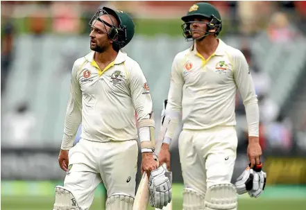  ?? GETTY IMAGES ?? Australian tailenders Nathan Lyon, left, and Josh Hazlewood trudge off the Adelaide Oval after losing the first test against India.