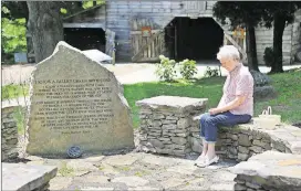  ?? CURTIS COMPTON / CCOMPTON@AJC.COM ?? Hannah Barber sits in one of the islands along the poetry trail at the Byron Herbert Reece Farm and Heritage Center in Blairsvill­e.