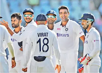  ?? — PTI ?? R. Ashwin (second from right) celebrates with teammates after dismissing New Zealand batsman Ross Taylor on the third day of the second Test at the Wankhede Stadium in Mumbai on Sunday.