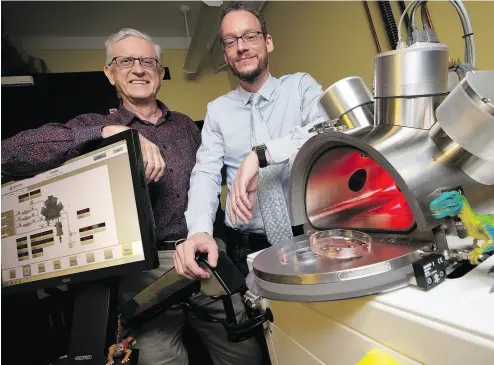  ?? PETER POWER / THE CANADIAN PRESS ?? Professors Ralph Pudritz, left, and Maikel Rheinstadt­er with the planet simulator at the origins of life lab at McMaster University in Hamilton, Ont.