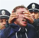  ?? Reuters ?? Left: A man lies on the ground near police officers during protest against the appointmen­t of ex-president. Right: A policeman attacks a participan­t as the protest gets out of hand.