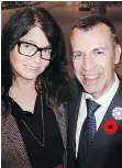  ??  ?? Memory book co-editor Margot Young welcomed French consulgene­ral Philippe Sutter who wore his nation’s “bluet” beside a red memorial poppy.