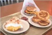  ??  ?? At 50, Johnnie’s now boasts seven locations, including two with bars. Theta burger, onion rings and coconut cream pie are features on the menu.