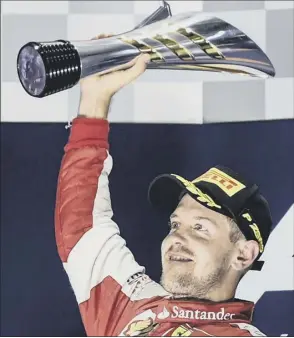  ?? Picture: Afp/getty ?? Sebastian Vettel stands aloft the podium to celebrate his victory