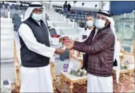  ??  ?? Director QOC Sports Affairs Dept Khalil Al Jaber presents a medal to Obaid Tahir.