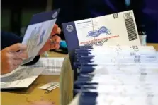  ?? AP PHOTO/MATT SLOCUM ?? In 2020, Chester County, Pa., election workers process mail-in and absentee ballots at West Chester University in West Chester, Pa.