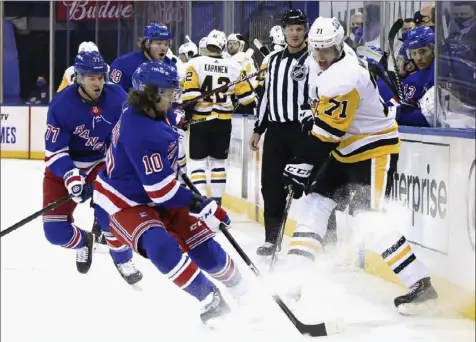 ?? Associated Press ?? Evgeni Malkin struggles to retain control of the puck Saturday night against the Rangers in New York.