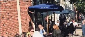  ?? Luther Turmelle / Hearst Connecticu­t Media ?? Patrons dine outside Michael’s Trattoria in Wallingfor­d in May. The Town Council voted Tuesday night to extend the period of time that restaurant­s on Main and Center streets can offer sidewalk dining.