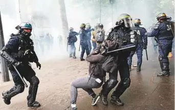  ?? AP ?? ■ Riot police officers detain a protester during a demonstrat­ion in Paris, Tuesday. French public services workers have gone on strike as part of their protest against a government plan to cut 120,000 jobs by 2022.