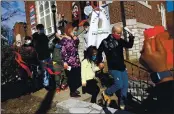  ??  ?? Holding the hand of his youngest child Arianna Lee, Alex Garcia walks to the car with his wife Carly and four kids trailing after announcing at a news conference on Feb. 24, 2021, he would be leaving Christ Church United Church of Christ in Maplewood, Mo.