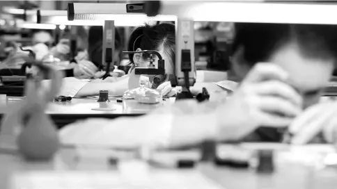  ??  ?? Watch makers sit at work benches during luxury wristwatch manufactur­e at the Glashuette Original watch factory in Glashuette, Germany, on Feb 23.