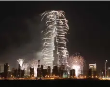  ?? Pawan Singh / The National ?? Fireworks cascade from Burj Khalifa as the bells strike midnight on New Year’s Eve