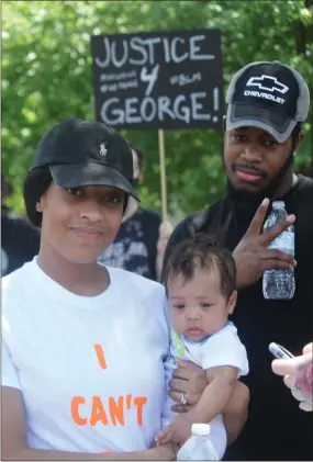  ?? JEN SAMUEL — MEDIANEWS GROUP ?? A family attends a peaceful demonstrat­ion as community members deliver remarks calling for criminal justice reform in America.