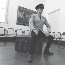  ??  ?? Actor Joe Sfair, who plays the title role in a First World War rendition of Henry V, prepares to perform in the historic Stearns mansion as part of the Shakespear­e in Detroit theatre group.