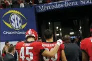  ?? ASSOCIATED PRESS FILE ?? Georgia’s Luke Ford (45) and Charlie Woerner (89) head to the locker room after losing to Alabama in the SEC championsh­ip game in Atlanta.