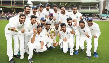  ?? — AFP photo ?? India’s team pose with the Border-Gavaskar trophy as they celebrate their series win on the fifth day of the fourth and final cricket Test against Australia at the Sydney Cricket Ground in Sydney in this Jan 7 file photo.