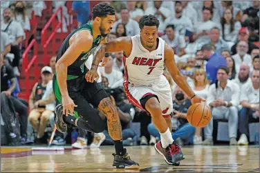  ?? Associated Press ?? One on one: Miami Heat guard Kyle Lowry (7) dribbles the ball around Boston Celtics forward Jayson Tatum (0) during the first half of Game 5 of the NBA basketball Eastern Conference finals playoff series Wednesday in Miami.