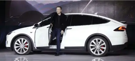  ?? MARCIO JOSE SANCHEZ/THE ASSOCIATED PRESS FILE PHOTO ?? Elon Musk, CEO of Tesla Motors Inc., with the Model X in September 2015. Tesla reported a loss in profit of $400 million (U.S.) in its first quarter.