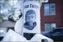  ?? E. JASON WAMBSGANS/CHICAGO TRIBUNE ?? An image of Adam Toledo appears at a memorial site on Thursday, near where he was fatally shot by Chicago police in the Little Village neighborho­od.