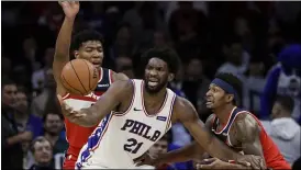  ?? MATT ROURKE — THE ASSOCIATED PRESS ?? When it comes time for Sixers center Joel Embiid — center, being defended by Washington’s Rui Hachimura, left, and Bradley Beal in a preseason game — to have his minutes limited this season, such moves won’t be broadcast by the club.