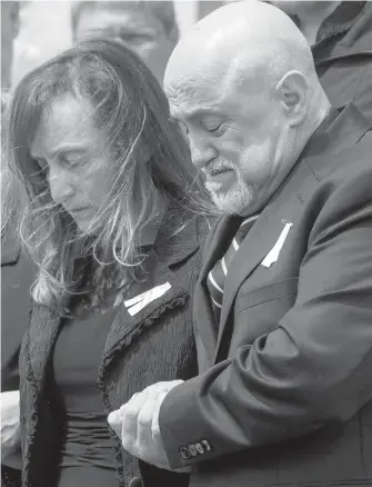  ??  ?? Carmela and Rocco D'Amico follow the casket of daughter Anne Marie out of the church Wednesday.