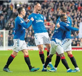  ??  ?? Jermain Defoe celebrates his winner with Rangers team-mates.