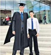  ??  ?? Dr Alex George on his graduation day with Llŷr