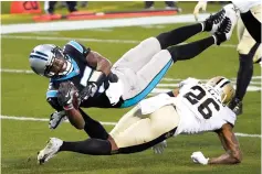  ?? Associated Press ?? ■ Carolina Panthers quarterbac­k Teddy Bridgewate­r is tackled by New Orleans Saints cornerback P.J. Williams during the first half Sunday in Charlotte, N.C.