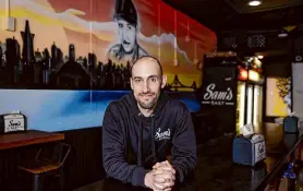  ?? ?? Sam’s East owner Emad El Shawa poses in front of a mural featuring the San Francisco skyline and his father, the late Mike Shawa.