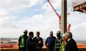  ?? ?? Joe Biden speaks with the chairman of TSMC, Mark Liu, during a visit to the site of its planned semiconduc­tor plant in Phoenix on 6 December 2022. Photograph: Jonathan Ernst/